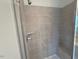 Modern bathroom shower with gray tile, glass door, and built-in shelf and seating at 1006 Regalia Rd # 4, Durham, NC 27713
