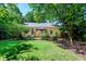 Landscaped backyard showing the exterior, patio, and lawn, perfect for outdoor activities at 1008 Mockingbird Dr, Raleigh, NC 27615