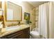 Well-lit bathroom featuring granite counters, vanity, shower, toilet, and a shower with tile accents at 1008 Mockingbird Dr, Raleigh, NC 27615