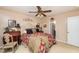 Comfortable bedroom with ceiling fan, ample natural light, and ensuite bathroom for primary suite at 1008 Mockingbird Dr, Raleigh, NC 27615