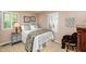 Serene bedroom featuring plantation shutters, bedside table, and neutral tones for a calming atmosphere at 1008 Mockingbird Dr, Raleigh, NC 27615
