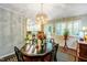 Elegant dining room with decorative chandelier, and view of kitchen for Gathering gatherings at 1008 Mockingbird Dr, Raleigh, NC 27615