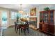 Elegant dining room with brick fireplace, decorative chandelier, and traditional furnishings for formal gatherings at 1008 Mockingbird Dr, Raleigh, NC 27615