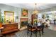 Elegant dining room with brick fireplace, decorative chandelier, and view to living room for Gathering gatherings at 1008 Mockingbird Dr, Raleigh, NC 27615