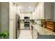 Updated kitchen showcasing stainless steel appliances, granite counters, and ample cabinet space at 1008 Mockingbird Dr, Raleigh, NC 27615