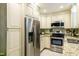 Kitchen featuring stainless steel appliances, granite countertops, and off-white cabinets at 1008 Mockingbird Dr, Raleigh, NC 27615