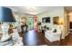 Comfortable living room featuring hardwood floors, bright natural light and red front door with sidelights at 1008 Mockingbird Dr, Raleigh, NC 27615