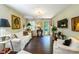 Comfortable living room featuring hardwood floors, bright natural light and red front door at 1008 Mockingbird Dr, Raleigh, NC 27615