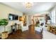 Bright living room featuring hardwood floors, comfortable seating, and an open layout perfect for entertaining guests at 1008 Mockingbird Dr, Raleigh, NC 27615