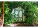 Backyard shed providing convenient storage, surrounded by lush greenery and natural elements at 1008 Mockingbird Dr, Raleigh, NC 27615
