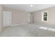 Bedroom with bright light, neutral walls, and gray carpeted floor at 1029 Whitehall Cir, Durham, NC 27713