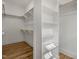 Spacious walk-in closet features custom shelving and hanging rods for optimal storage at 1029 Whitehall Cir, Durham, NC 27713
