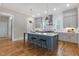 Modern kitchen with a spacious island, pendant lighting, and stainless steel appliances at 1029 Whitehall Cir, Durham, NC 27713