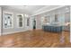 Open-concept living space with hardwood floors leading to a modern kitchen area at 1029 Whitehall Cir, Durham, NC 27713
