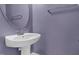 Powder room featuring a white pedestal sink, a round mirror, and brushed nickel hardware at 105 Walehurst Ridge Dr, Angier, NC 27501