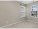 An empty bedroom featuring two windows offering natural light and neutral carpet at 105 Walehurst Ridge Dr, Angier, NC 27501