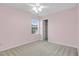 A bedroom with pink walls, natural light, and neutral carpeting at 105 Walehurst Ridge Dr, Angier, NC 27501