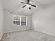 Empty bedroom with plush carpet, large window, and neutral paint at 105 Walehurst Ridge Dr, Angier, NC 27501
