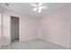 A sparsely decorated pink bedroom, with an open closet, neutral carpet, and natural light at 105 Walehurst Ridge Dr, Angier, NC 27501