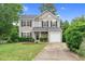 Charming two-story home boasts manicured landscaping, neutral siding, and a stone-accented front entrance at 105 Walehurst Ridge Dr, Angier, NC 27501