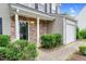 Welcoming front entrance with stone facade, well-maintained landscaping, and covered entry at 105 Walehurst Ridge Dr, Angier, NC 27501