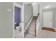 Hallway with carpeted stairs and a half bathroom with grey walls at 105 Walehurst Ridge Dr, Angier, NC 27501
