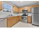 Functional kitchen with stainless steel appliances, bright countertops, and ample cabinet space at 105 Walehurst Ridge Dr, Angier, NC 27501