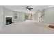 Open living room with fireplace, seamlessly connected to the dining area and kitchen with staircase at 105 Walehurst Ridge Dr, Angier, NC 27501