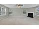 Spacious living room with fireplace, ample windows, and plush carpeting, perfect for relaxation at 105 Walehurst Ridge Dr, Angier, NC 27501