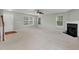 A bright living room features neutral paint, carpet, fireplace, and windows for ample natural light at 105 Walehurst Ridge Dr, Angier, NC 27501