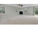 Large living room with ample natural light, cozy fireplace, and plush carpeting at 105 Walehurst Ridge Dr, Angier, NC 27501