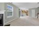 Open-concept living room featuring a fireplace, natural light, and view into the kitchen at 105 Walehurst Ridge Dr, Angier, NC 27501