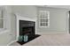 Comfortable living room featuring a classic fireplace, bright windows, and soft carpeting at 105 Walehurst Ridge Dr, Angier, NC 27501