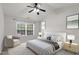 Well-lit main bedroom features a ceiling fan, large windows, and neutral decor at 105 Walehurst Ridge Dr, Angier, NC 27501