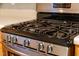 Close up of a stainless steel gas range with light wood cabinets at 105 Walehurst Ridge Dr, Angier, NC 27501