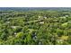 High-angle view of a home surrounded by extensive woods and some cleared land, emphasizing privacy and natural beauty at 1052 Hughes Trl, Elon, NC 27244