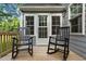 Inviting back porch features two rocking chairs, providing a cozy outdoor space at 1052 Hughes Trl, Elon, NC 27244