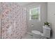 Cozy bathroom features a decorative shower curtain, and bright natural light at 1052 Hughes Trl, Elon, NC 27244