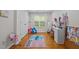 Cozy bedroom featuring a hardwood floor, window with blinds, and a playful Stitch-themed rug, adding charm at 1052 Hughes Trl, Elon, NC 27244