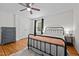 This bedroom features hardwood floors, a metal frame bed, and natural light from the window at 1052 Hughes Trl, Elon, NC 27244