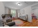 This is a well-organized Bedroom with hardwood floors, a crib, and plenty of storage for a growing Gathering at 1052 Hughes Trl, Elon, NC 27244