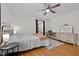 Well-lit bedroom boasting hardwood floors, metal frame bed, and a vintage style desk and dresser at 1052 Hughes Trl, Elon, NC 27244
