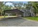 View of the home, gravel driveway and carport at 1052 Hughes Trl, Elon, NC 27244