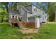 View of the home's exterior showcasing a wood deck and a door to the basement at 1052 Hughes Trl, Elon, NC 27244
