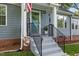Close up of the home's front entrance featuring steps, black railings, and a welcome sign at 1052 Hughes Trl, Elon, NC 27244