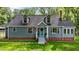 Charming home featuring dormer windows, a brick foundation, manicured lawn and inviting covered front entrance at 1052 Hughes Trl, Elon, NC 27244