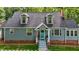 Beautiful home boasting dormer windows, gray siding, brick foundation, and a welcoming covered entrance at 1052 Hughes Trl, Elon, NC 27244