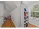 Hallway area featuring a built-in bookcase with storage and a window for natural light at 1052 Hughes Trl, Elon, NC 27244