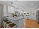 Bright kitchen features a breakfast bar with granite countertops, stainless appliances and hardwood floors at 1052 Hughes Trl, Elon, NC 27244