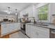 Beautiful kitchen with white cabinets, granite countertops, and stainless steel appliances at 1052 Hughes Trl, Elon, NC 27244